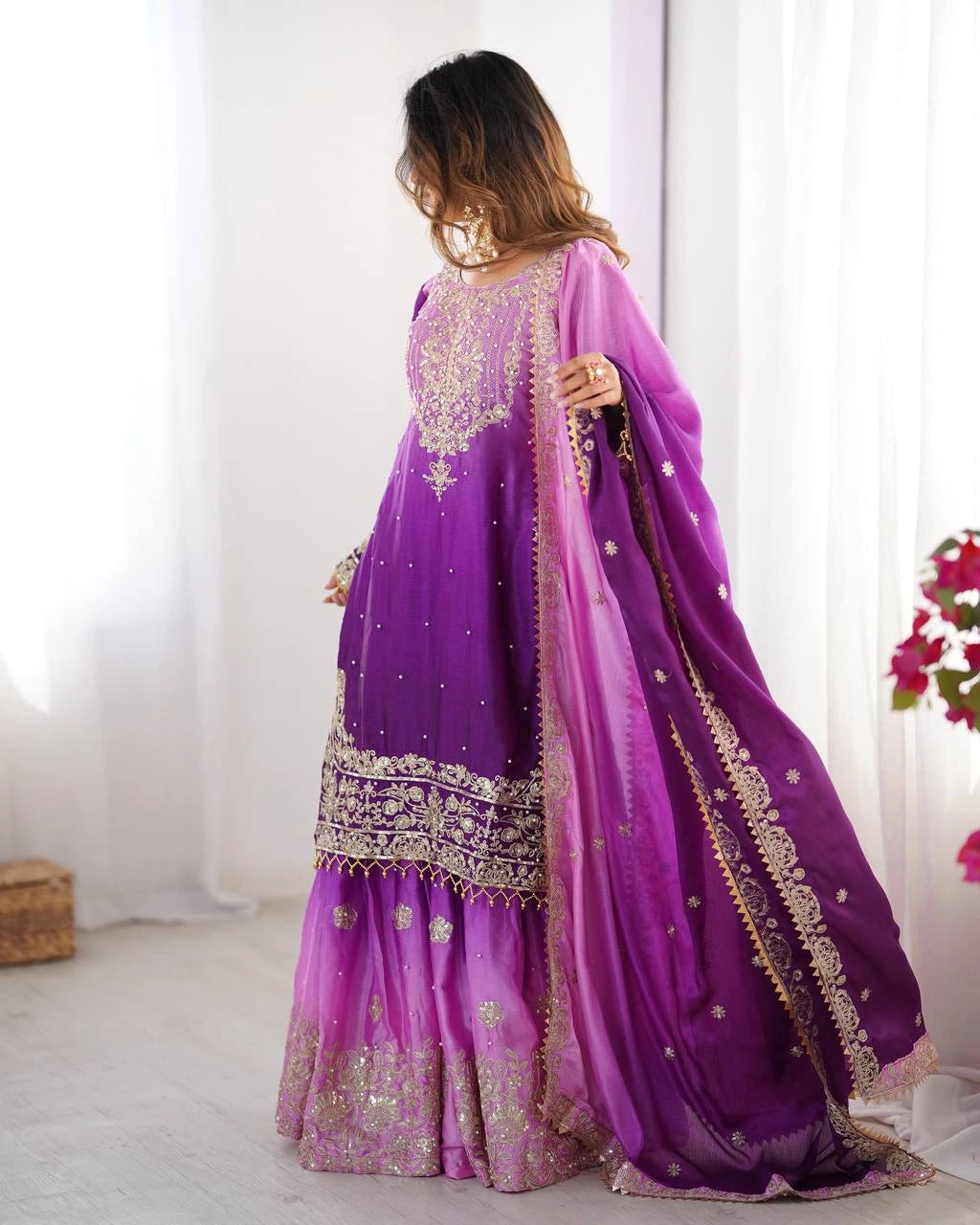 Purple embroidered traditional outfit with a matching dupatta on a white background